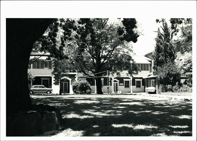 Front elevation of Brown House (partially obscured by tree)