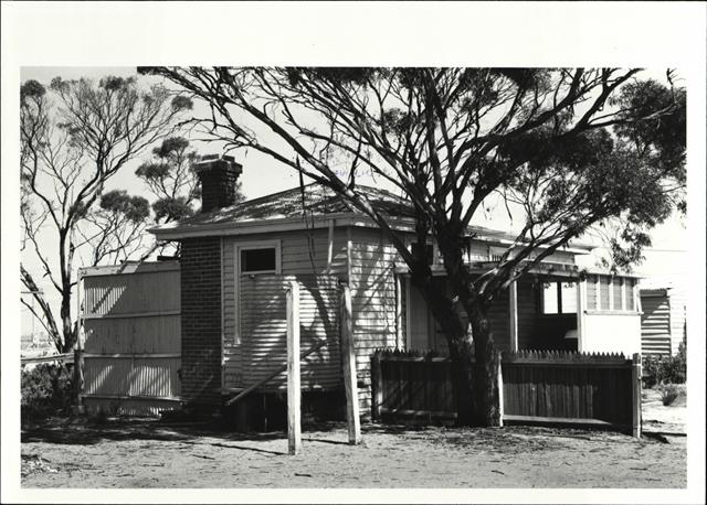 Corner elevation of lock-up (partially obscured by tree and rainwater tank)