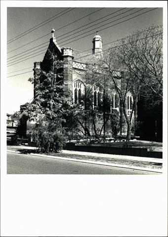 Right corner elevation of church (partially obscured by trees)
