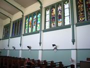 Interior of nave showing stained glass windows on north wall