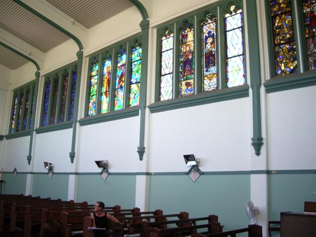 Interior of nave showing stained glass windows on north wall