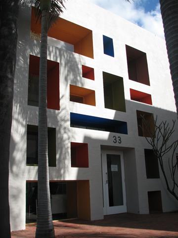 Exterior view of deep windows and entrance on north elevation