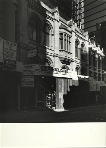 Angled front elevation of building façade (lower half obscured by scafolding)