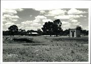 Loading ramp and shed in foreground, solitary remaining building in the backgrou