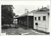 Angled rear elevation of building showing later addition