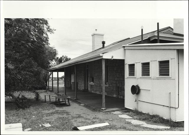 Angled rear elevation of building showing later addition