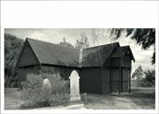 Front corner elevation with gravestones in the foreground