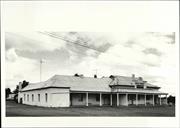 Angled front elevation of building showing later South wing