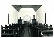 Interior elevation looking towards the altar with pews in the foreground