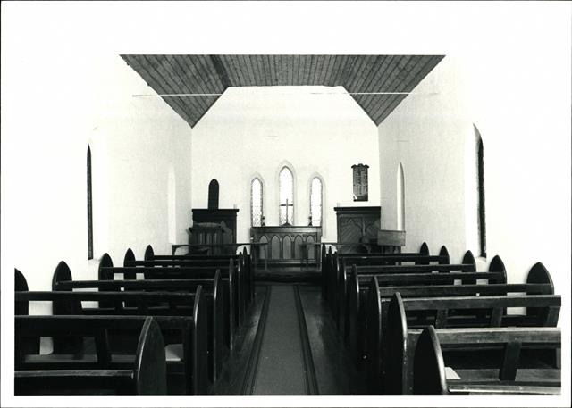 Interior elevation looking towards the altar with pews in the foreground