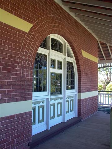 Detail of arched opening to south elevation showing foor, casement sashes and fa