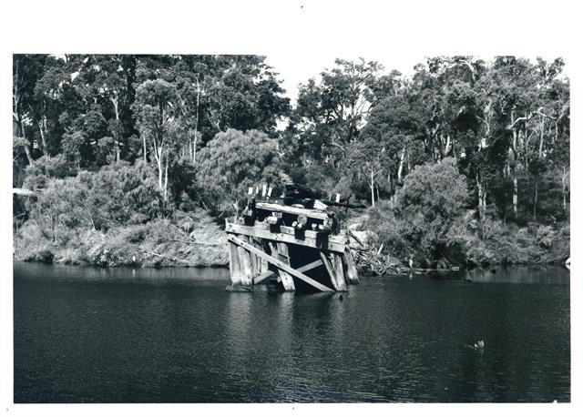 Old bridge jarrah support snapped off in fracture of bridge by floods