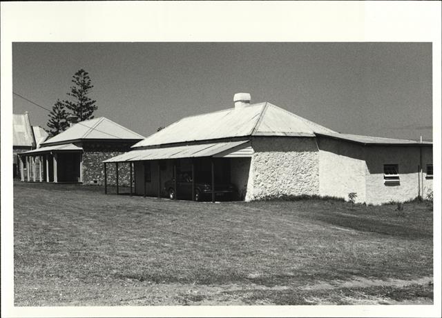 Corner elevation of building showing preist's house on left