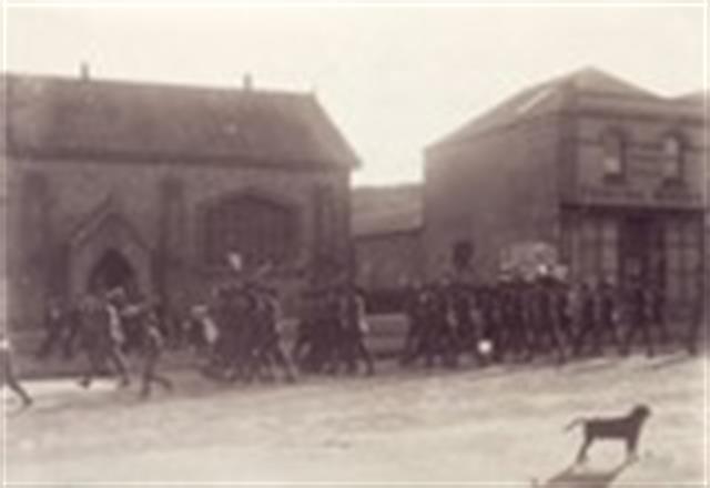 Soldiers marching in front of the ALbany Advertiser