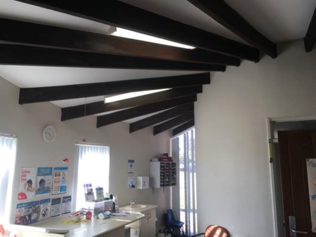 2021 interior showing exposed ceiling joists and entrance to storeroom