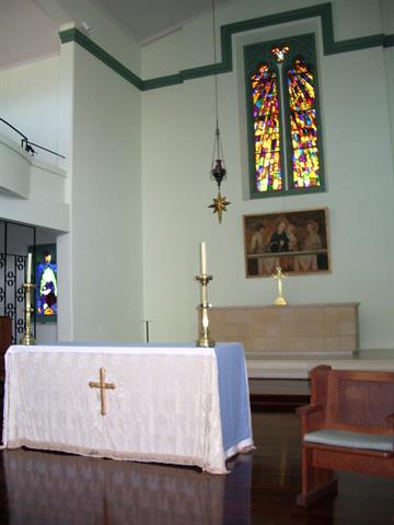 Interior view showing altar and stained glass window