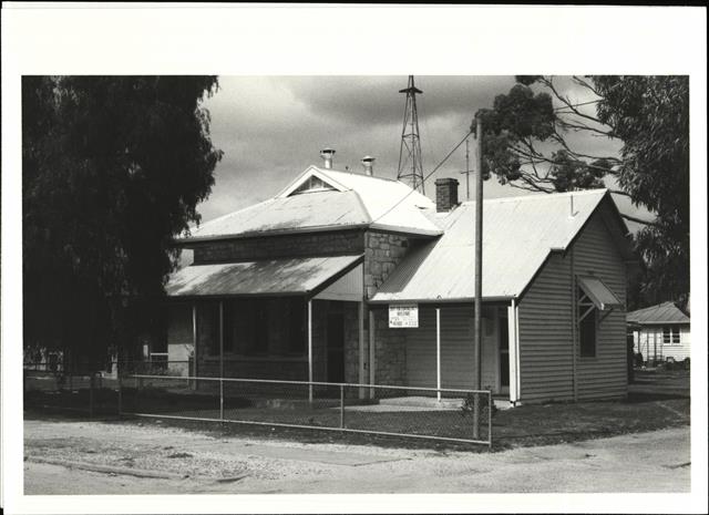 Angled front elevation of court house showing later wooden addition