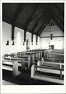Interior view from East end of church showing pews and entrance