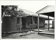 Angled side view of building with water tank prominent