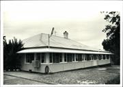 Front corner elevation of early building with an enclosed verandah