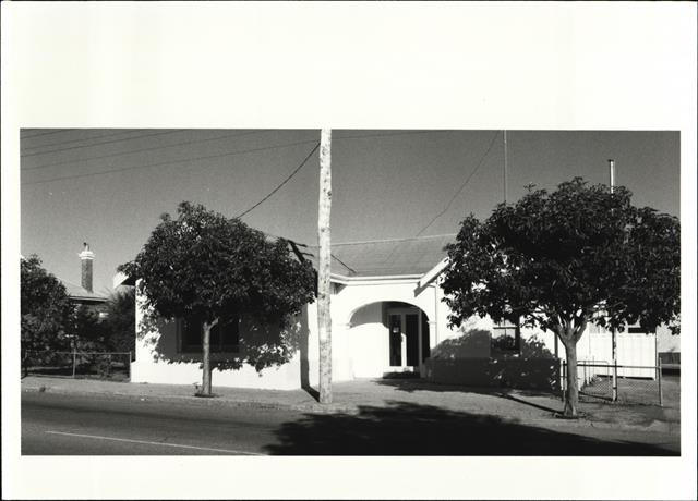 Front elevation of court house (obscured by trees)