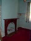 Deb with fireplace surround and built-in furniture. Shelf unit with seat visible