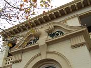 scrolled broken pediment over front porch