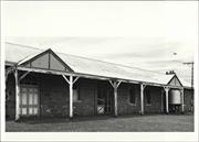 Angled front elevation of building showing detail of gate entrance