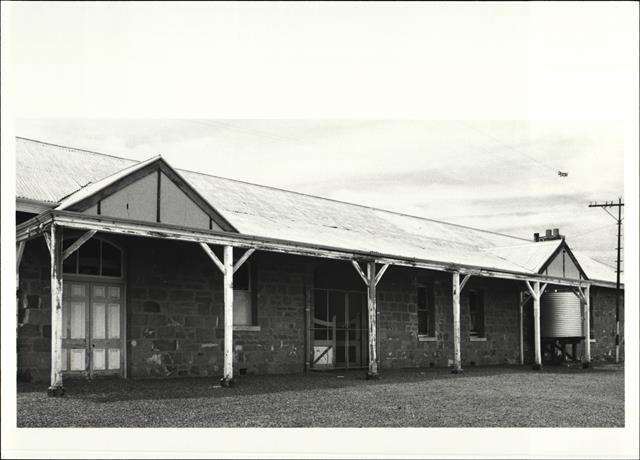 Angled front elevation of building showing detail of gate entrance
