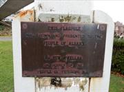 Plaque on flagpole - north-eastern corner of garden