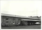 Side elevation of building from South showing unpainted stone construction