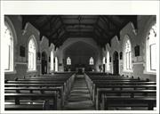 Interior view of church facing altar with pews in foreground