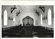 Interior elevation facing the altar and cross with pews in the foreground