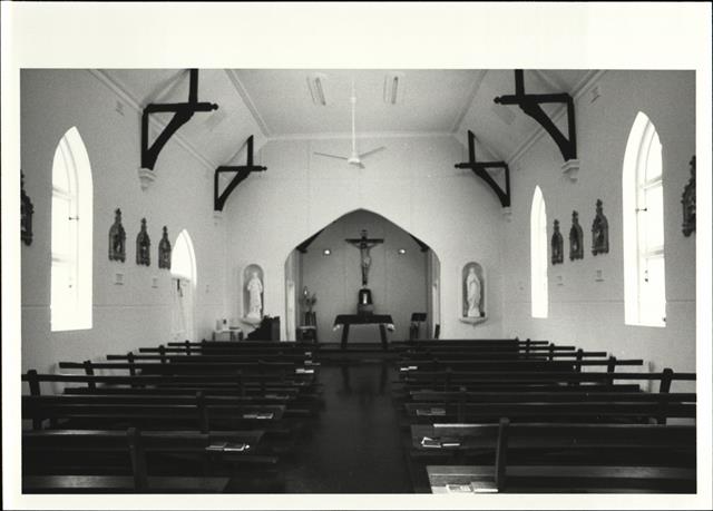 Interior elevation facing the altar and cross with pews in the foreground