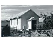 Front entry view of the church, recently rendered, showing some graveyard in for
