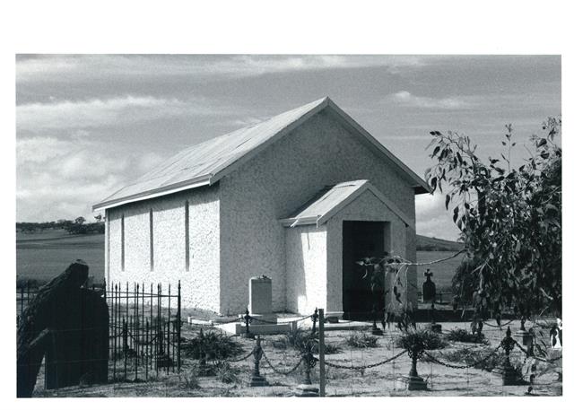 Front entry view of the church, recently rendered, showing some graveyard in for