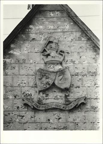 Detail of the school coat of arms, with motto
