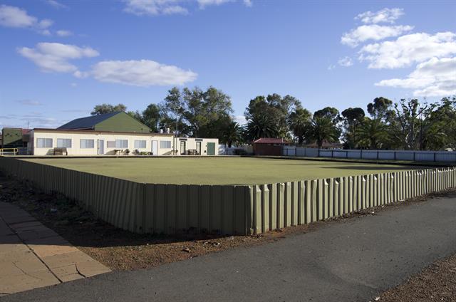 Front elevation of bowling pavilion with bowling green in foreground