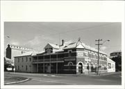 Contextual front corner elevation of building