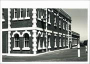 Angled view of West side of building showing quoins & windows