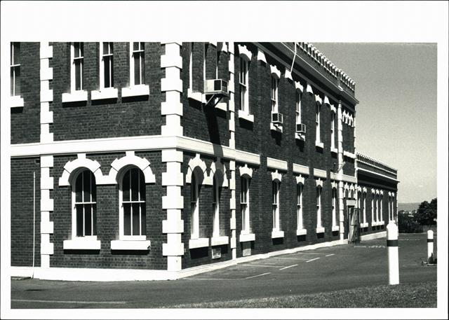 Angled view of West side of building showing quoins & windows