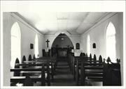 Closer interior elevation facing the altar and cross with pews in the foreground