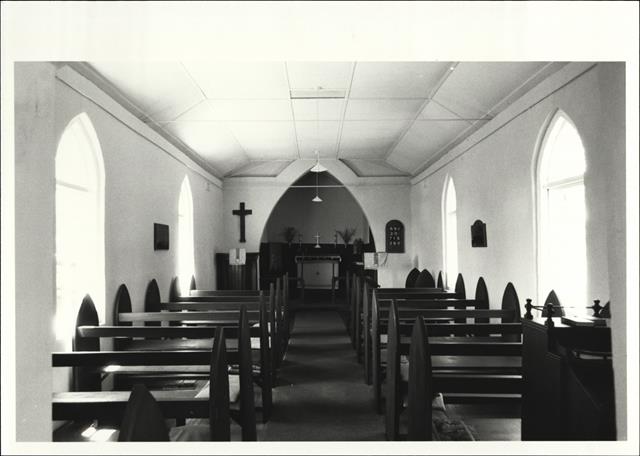 Closer interior elevation facing the altar and cross with pews in the foreground