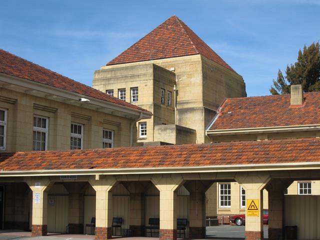 View south across cloisters, main hall on left and entrance beyond