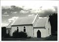 Front corner elevation, church bell visible on the side of the building