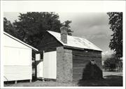 Corner elevation of original building with later building shown adjacent
