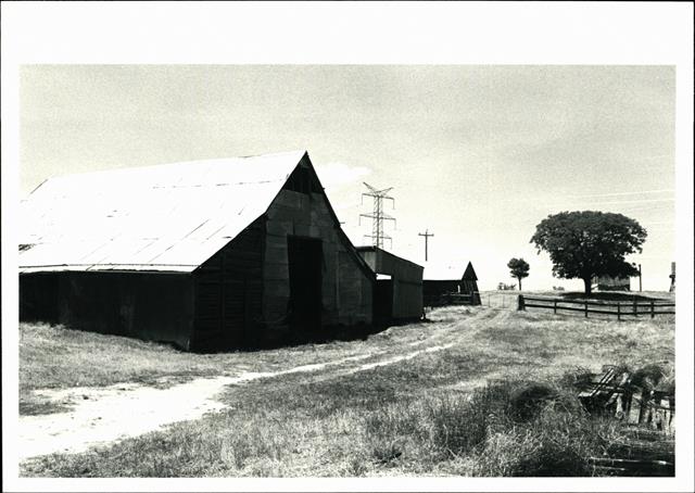Left corner elevation of barn showing other buildings in background