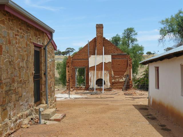 View of inn ruin between schoolhouse (l) and homestead (r)