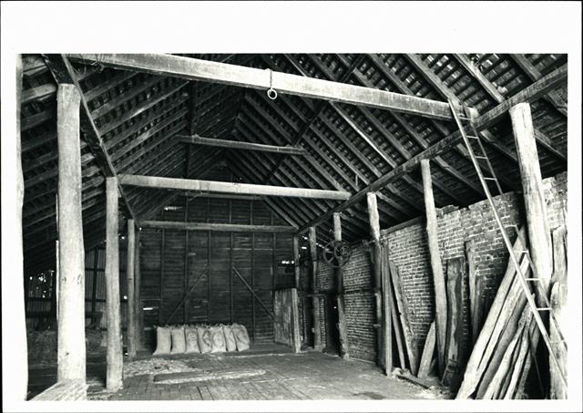 Interior view of barn showing ceiling beams, rafters & purlines