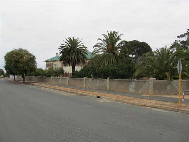 view looking south east along Amherst St showing house and gardens
